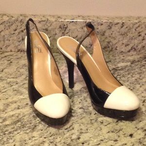 Black patent leather pumps w/ white cap toe detail